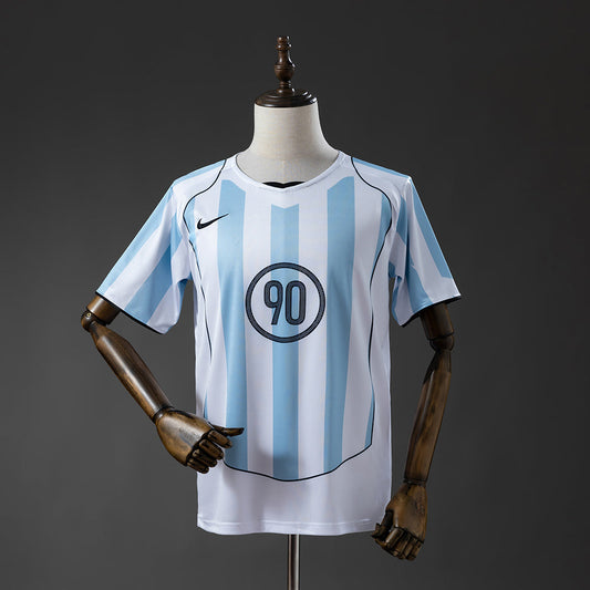 Camiseta T90 2025 - Blanca y Azul